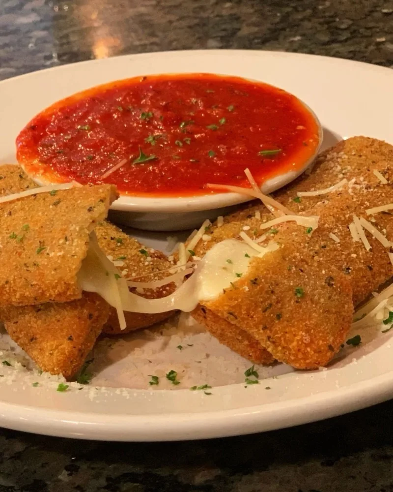 Homemade fried mozzarella appetizer with marinara sauce at Johnny Macaroni's